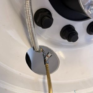 FLOW THROUGH CAPS FOR AUTO INFLATION SYSTEMS